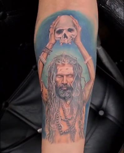 aghori sadhu holding skull tattoo design male forearm