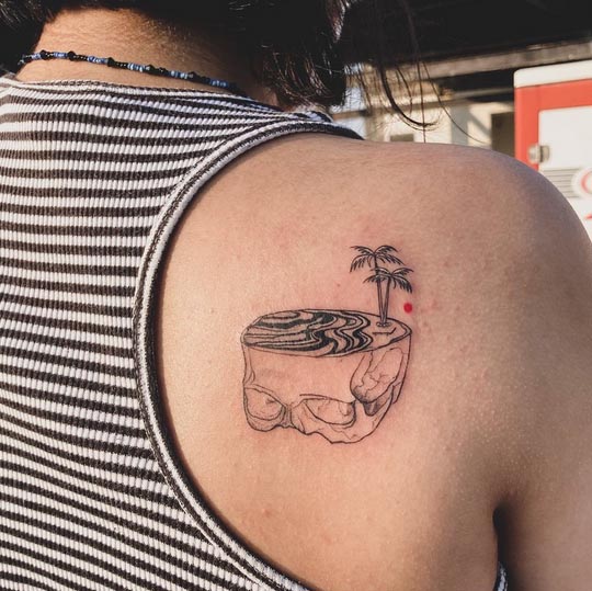 beach on half skull tattoo design female shoulder back