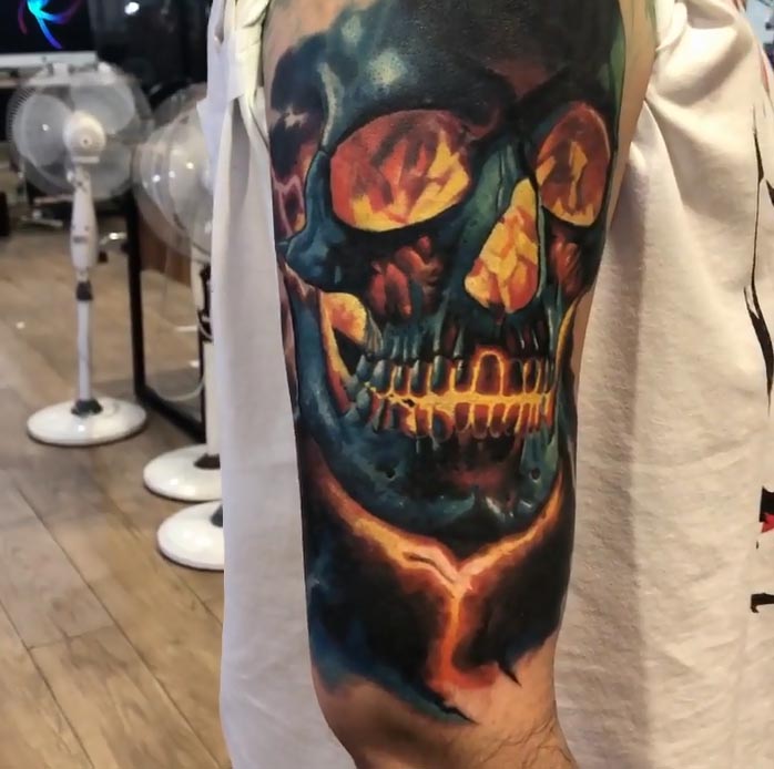 flaming inside skull tattoo idea for guys bicep