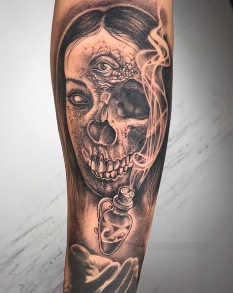 half woman half skull with magic potion tattoo male forearm