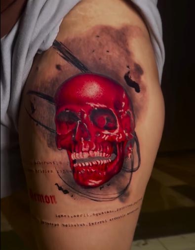 red skull word demon tattoo design female leg thigh