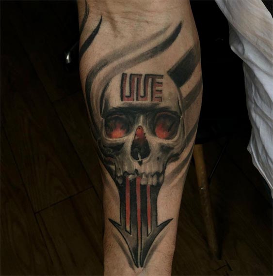 skull arrow out of mouth tattoo male hand forearm