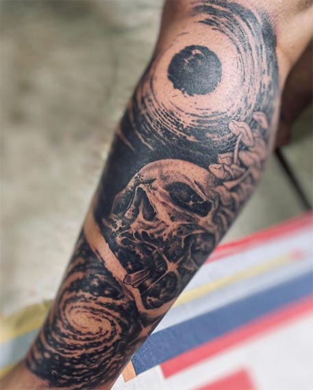 skull whirlpool tattoo design male forearm