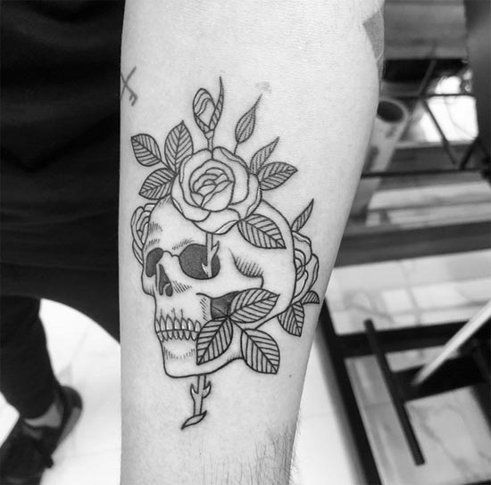 skull with rose in eye tattoo design linework male forearm