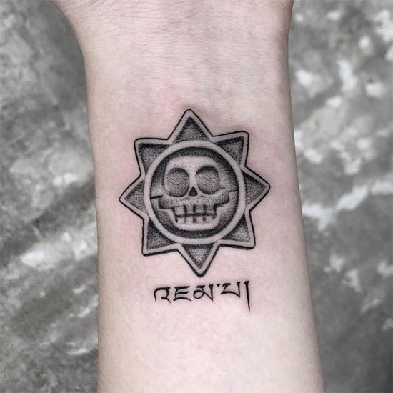 zuma skull tibetan script tattoo dotwork female forearm