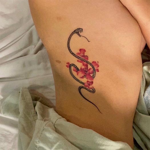 black snake with red flowers tattoo design girl side