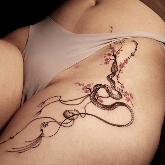cherry blossom snake dream catcher  tattoo female pelvic groin thigh