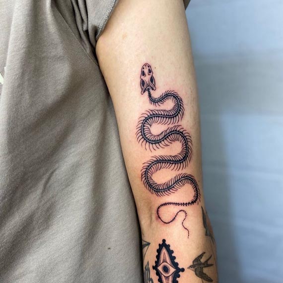 snake skeleton tattoo male bicep sleeve