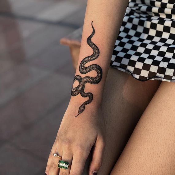 snake small tattoo design female forearm black and grey