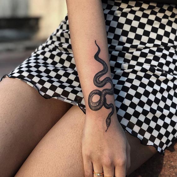 snake small tattoo design female forearm black and grey