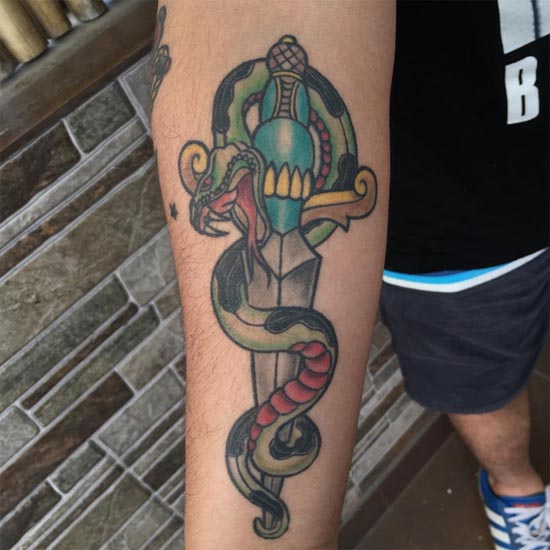 snake with dagger tattoo old school man forearm