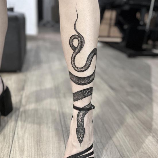 snake wrapped around leg tattoo female black and grey