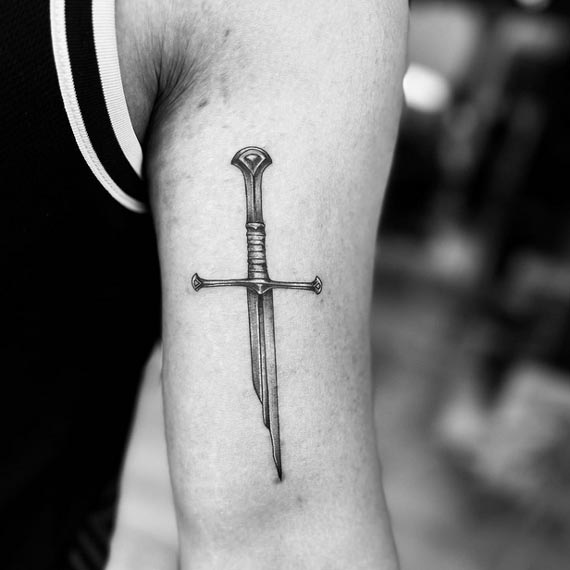 broken sword viking tattoo black and grey male bicep