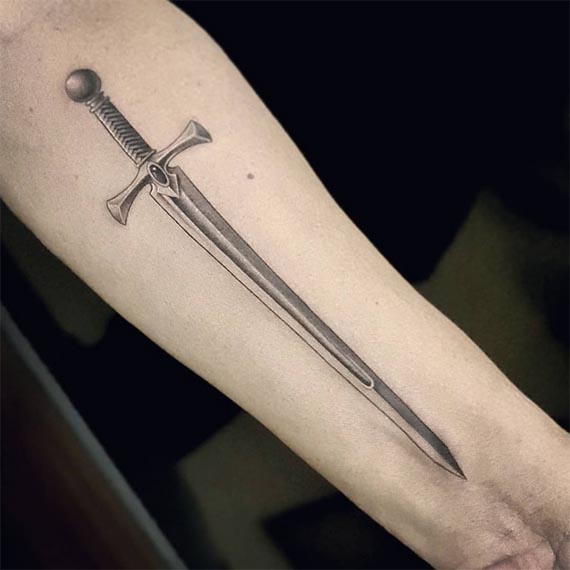 large sword tattoo design realistic black and grey male forearm