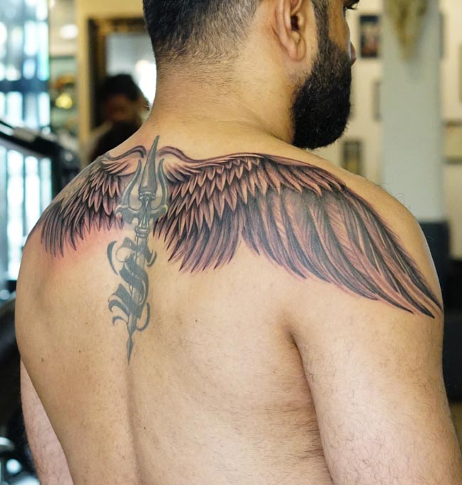 angel wings trishul in center tattoo on male back