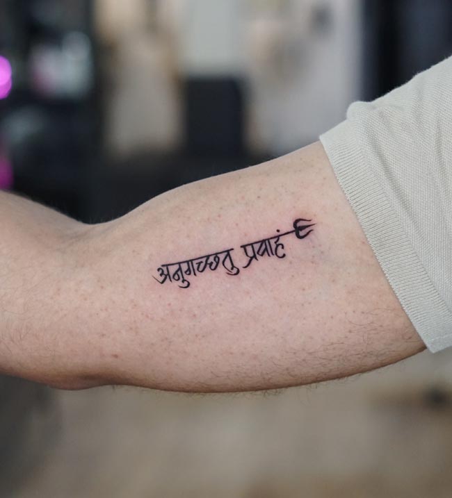 sanksrit text trishul on male inner bicep arm