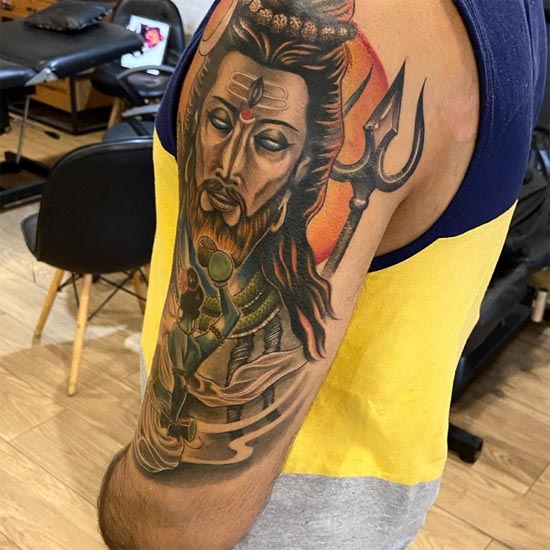 shakti with damru in front of mahadev shiva tattoo design color male bicep arm