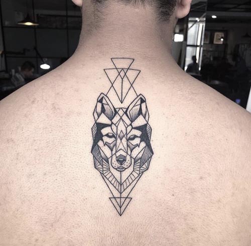 geometric wolf head and triangles above and below tattoo design male back