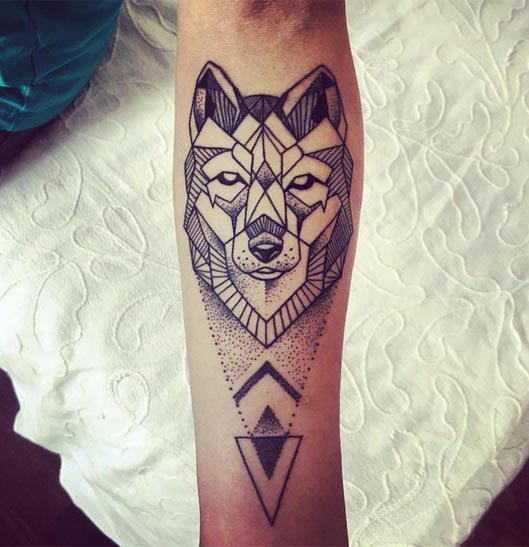 geometric wolf head below dotwork triangles tattoo male forearm