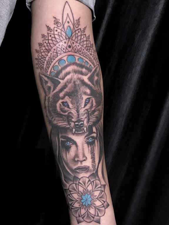 girl with wolf headdress top mandala unalome background below flower tattoo female forearm