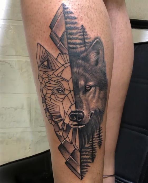 half geometric half real wolf head with trees tattoo female leg calf