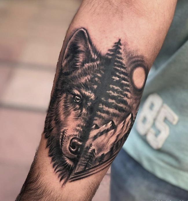 half realistic wolf head half jungle tattoo design male forearm