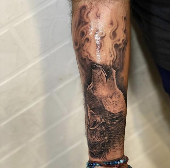 howling wolf head tattoo male forearm sleeve realism