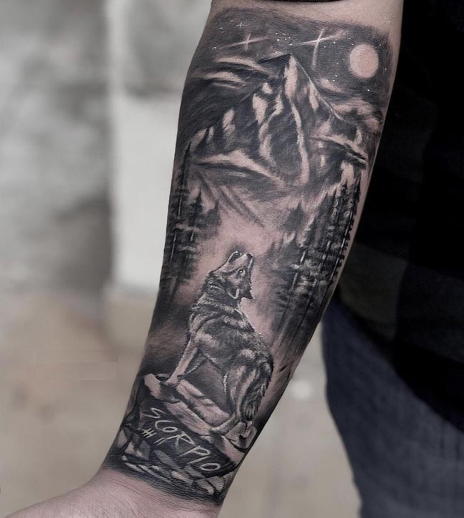 howling wolf standing on rock in jungle word scorpio below male forearm