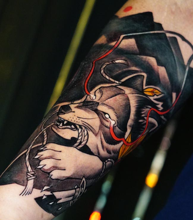wolf holding rope in mouth tattoo design male forearm