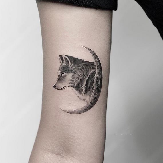 wolf side face crescent moon tattoo design female arm bicep