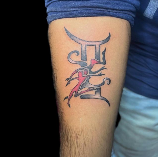 gemini zodiac sign tattoo on man forearm